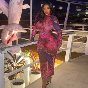 Close-up of slim-fit turtleneck dress with purple abstract print and long sleeves