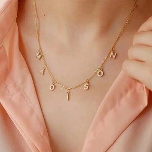 Detail of Madison name necklace in gold-plated stainless steel with zircon inlay