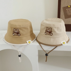 Baby bucket hats with cute bear patches in khaki and beige featuring adjustable chin straps