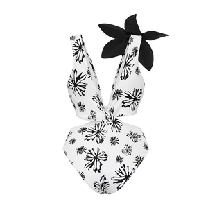 Detail of deep V-neck one-piece swimsuit with 3D floral accent and black floral print