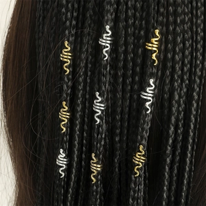 Detail of gold and silver snake dreadlock beads on black braided hair accessories