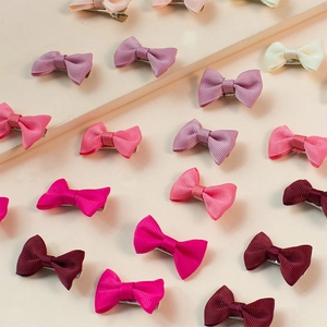 Close-up of assorted colorful grosgrain ribbon bows on metal hair clips set