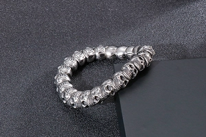 Close-up of vintage punk skull beads bracelet with antiqued silver finish and metal textures