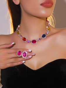 Detail showing high-quality colorful gemstone necklace and pink earrings on a model