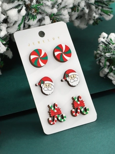 Detailed view of Christmas stud earrings set featuring Santa and candy cane designs