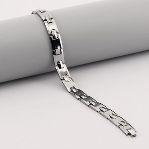 Sleek silver tungsten steel watch band link bracelet for men displayed on a jewelry stand
