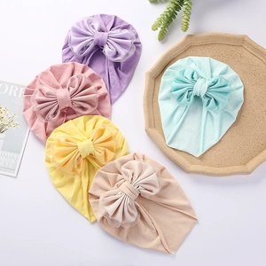 Detailed view of assorted colors baby turban hats with large soft mesh bow decor