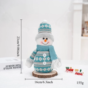Detailed size view of the blue snowman doll standing on a rustic wooden base with props