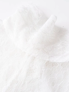 Close-up of white floral lace fabric texture and intricate embroidery details