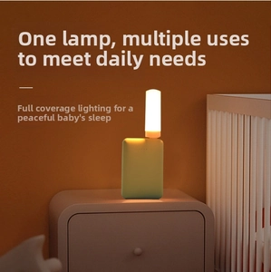 Close-up of portable USB warm yellow flame night light plugged into a green power bank