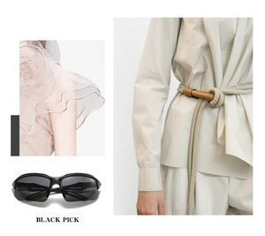 Macro detail of black cycling sunglasses paired with a beige woven belt and pink ruffle top