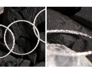 Macro detail of S925 sterling silver minimalist 1mm ring with sparkling textured finish
