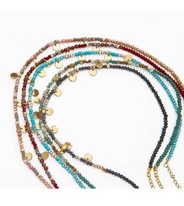 Detail of colorful stone beaded necklaces with gold metallic discs and adjustable clasps
