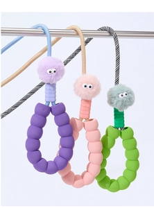 Detail of colorful bubble foam dog leashes with plush balls and ergonomic handles