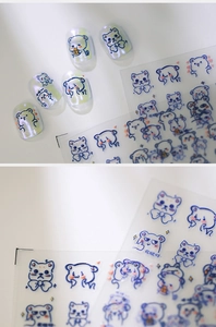 Macro detail of cute blue bear nail stickers on pearlescent nails with 3D texture