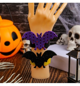 Detail of Halloween bat slap bracelets in purple sequins and black glitter on a model wrist