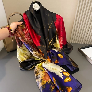 Floral butterfly print silk scarf with vibrant colors displayed against a premium background