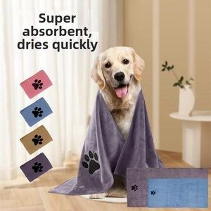 Golden Retriever wearing a purple microfiber pet towel with cute paw embroidery detail