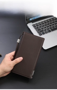 Dark brown leather long wallet with pebble grain texture and metal hardware wristlet