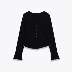 Women's V-neck black knit cardigan with white ruffled edges and metallic buttons