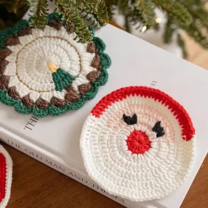 Handmade knitted Christmas coasters with tree and Santa designs for holiday table decor