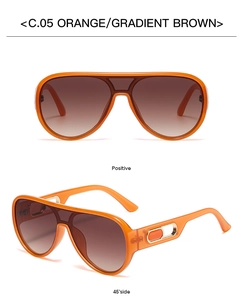 Detail of aviator sunglasses with orange frame, gradient brown lenses and hollow metal hinges