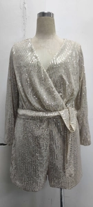 Detail of sequin romper dress with V-neckline and matching belt in champagne gold finish