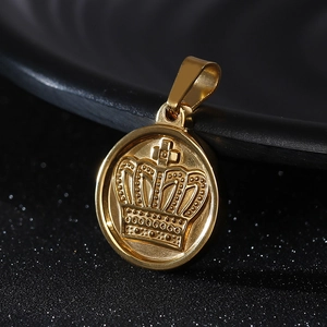 Macro shot of gold stainless steel round pendant featuring a detailed crown relief