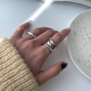 Close-up of irregular wide-faced silver ring with a minimalist liquid metal texture