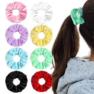 Set of 8 velvet hair scrunchies in multiple colors with a model wearing a mint green tie