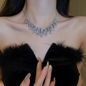 Detail view of rhinestone tassel necklace with pink and black crystals on model