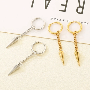 Macro detail of stainless steel hoop earrings with hanging spike and thin chain
