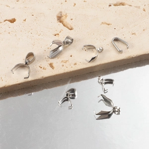 Polished stainless steel pinch bails for DIY jewelry making on stone background