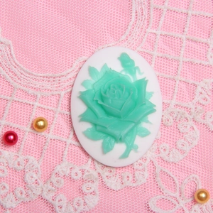 Oval resin rose cameo pendant with green flowers on white base for DIY jewelry making