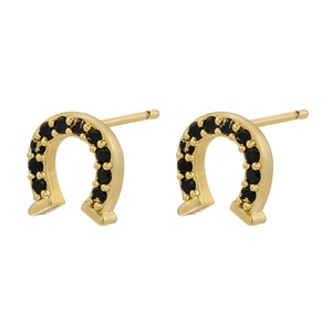 Close-up of golden horseshoe earrings featuring micro-paved black crystals on white background