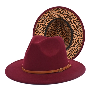 Detail of burgundy fedora hat featuring leopard print lining and studded leather belt