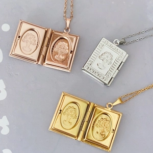 Close-up of 18K gold plated book-shaped locket necklace with tree relief pattern