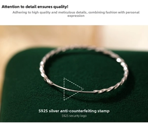 Macro view of S925 sterling silver twisted bangle with clear hallmark on velvet
