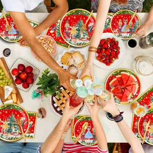 Nutcracker Christmas themed party tableware set with red plates and napkins on dining table