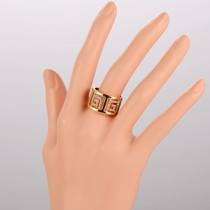 Exquisite gold-plated wide band ring with sparkling white rhinestones on a model's hand