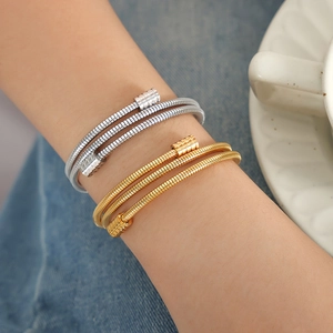Spiral twisted cuff bracelets in gold and silver finish for women on wrist