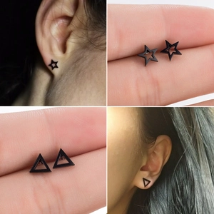 Detail shots of black geometric star and triangle stud earrings in stainless steel