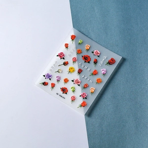 Macro detail of 5D embossed colorful rose nail stickers with realistic floral texture