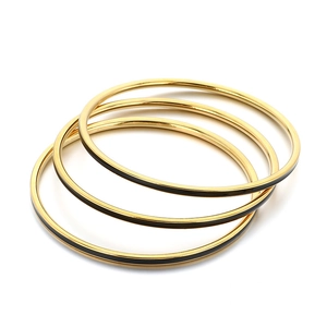 Three-piece stackable gold stainless steel 3mm bangles with black enamel inlay details