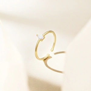 Detailed view of S925 silver ring featuring a pear-shaped white opal and gold finish
