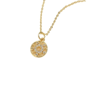 Minimalist gold necklace with circular star pendant and sparkling zircon accents
