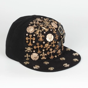 Detail of gothic flat brim hat with gold cross, skull charms and side leather straps