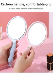 Detailed view of pink and blue ergonomic handheld mirrors with rabbit head handle design