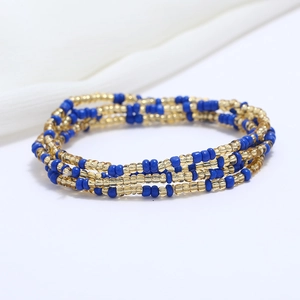 Close-up of double-layered blue and gold beaded waist chain for summer beach fashion