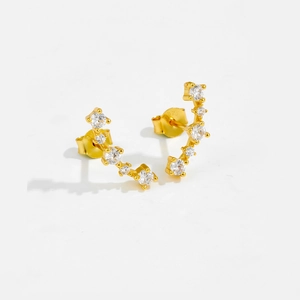 Macro detail of S925 sterling silver curved gold earrings with white cubic zirconia stones